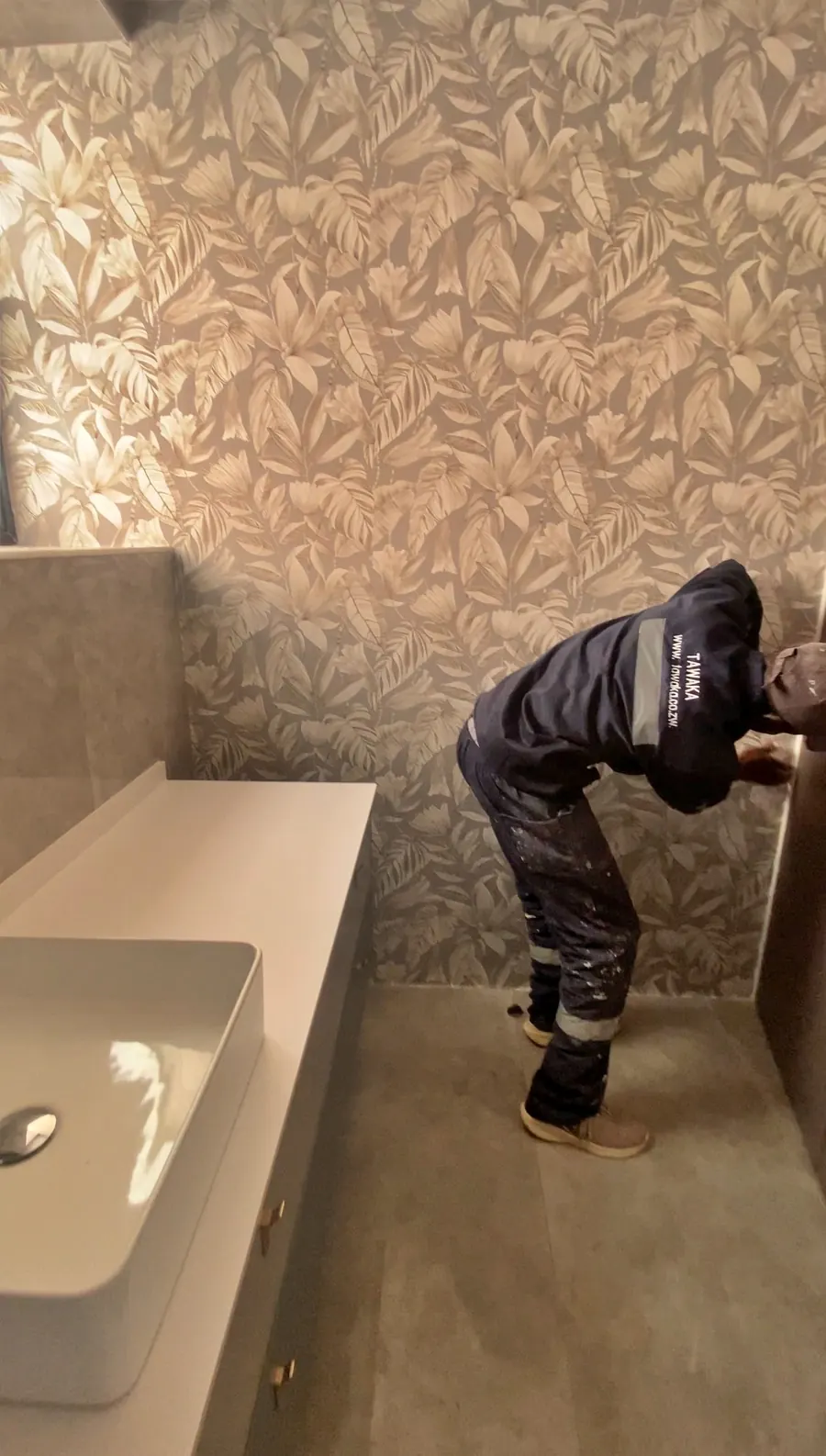 Completed Greendale bathroom by Tawaka Contracting with a botanical patterned feature wall, countertop basin and fitted