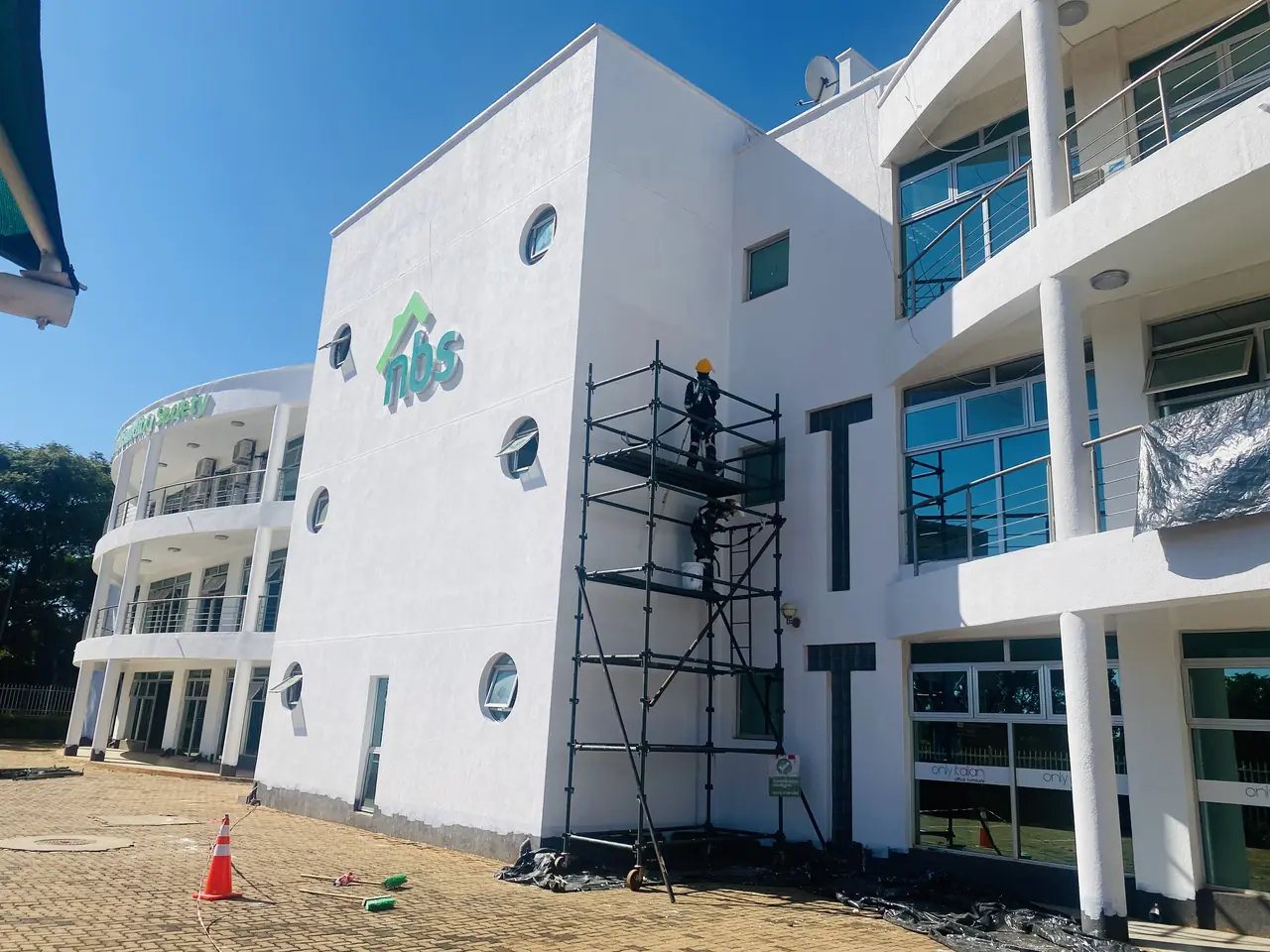 Commercial exterior painting contractor Harare — scaffolded office block facade being repainted by Tawaka Contracting