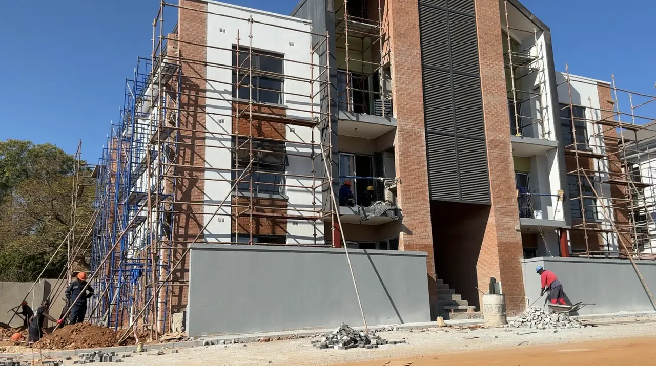 Construction company Harare — Tawaka Contracting team working on a multi-storey residential development under full scaffold in Zimbabwe