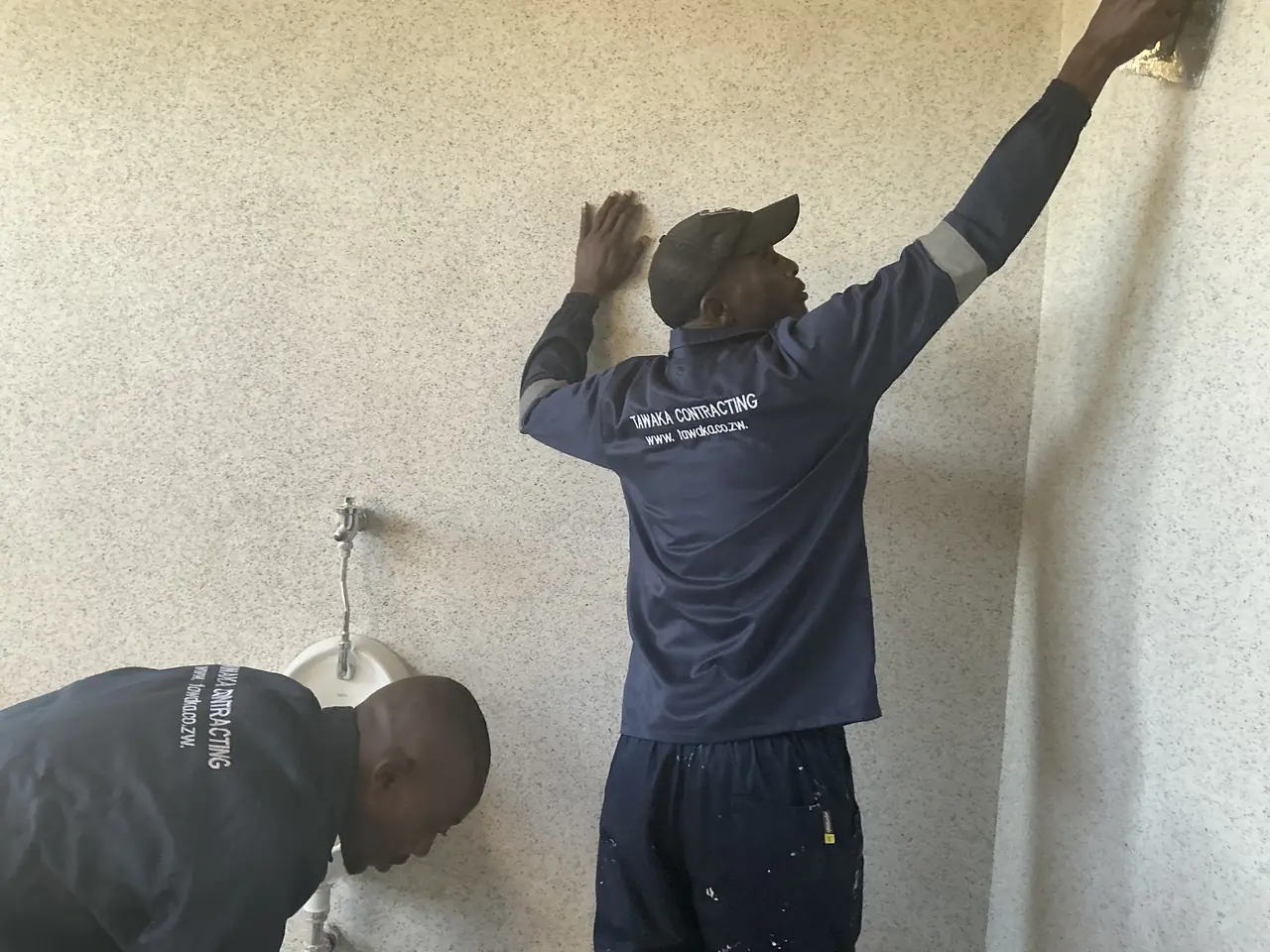 Decorative coatings Harare — Tawaka Contracting applying a specialist textured granite-effect wall coating in Borrowdale