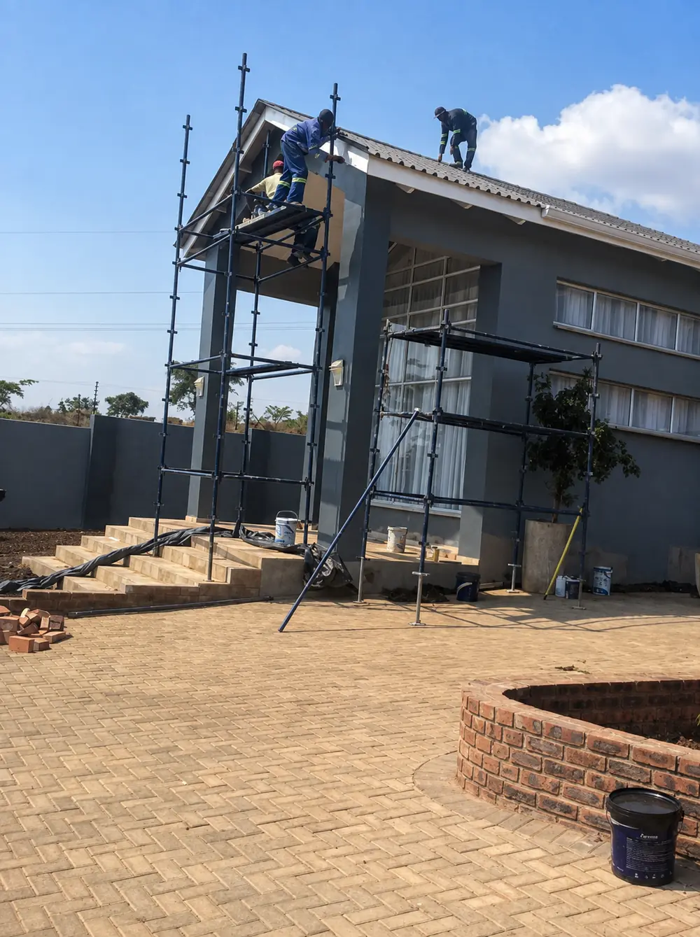 Construction works Harare — Tawaka Contracting team building and finishing a gable entrance portico from scaffold in Gletwin, Zimbabwe
