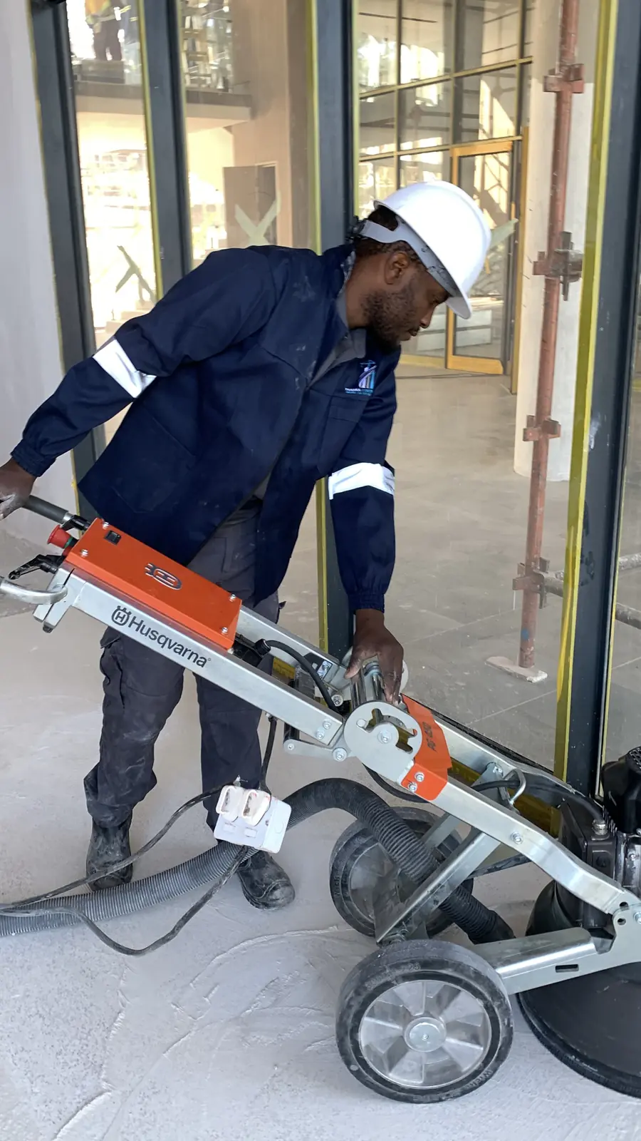 Commercial terrazzo grinding Harare — Tawaka Contracting operative machine-grinding a terrazzo floor at Highlands Park, Zimbabwe