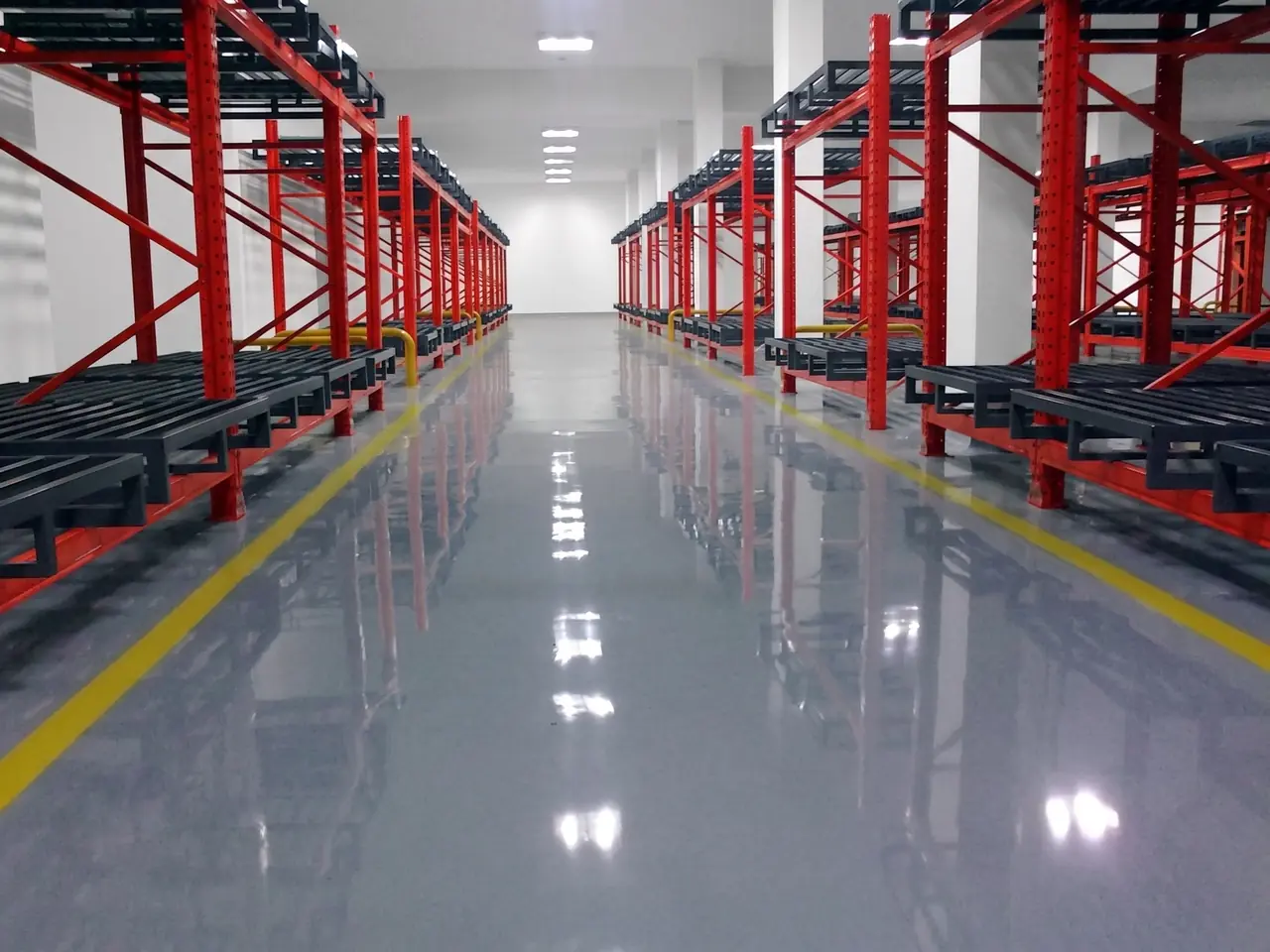 Polyurethane flooring Harare — heavy-duty resin floor with demarcation lines in a racked distribution warehouse
