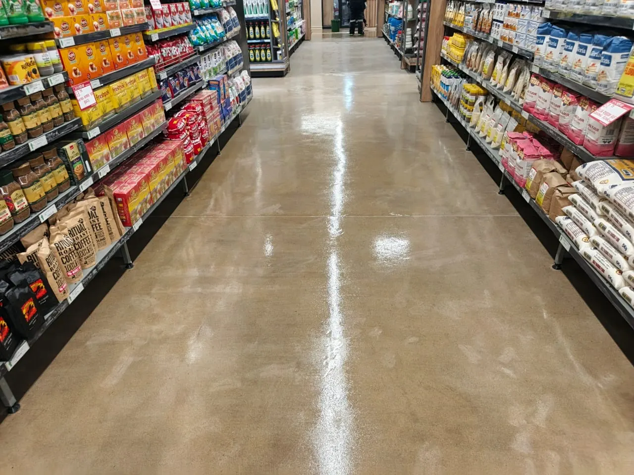 Seamless jointless resin floor running the length of a stocked supermarket aisle in Avondale, Zimbabwe