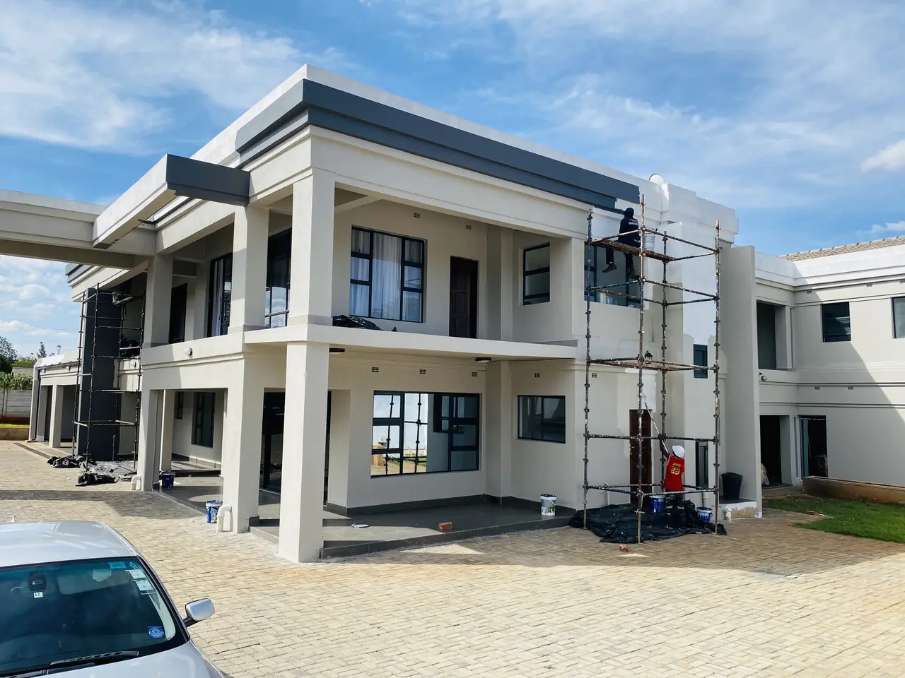 House painting Harare — scaffolded double-storey residence being painted by Tawaka Contracting in Borrowdale