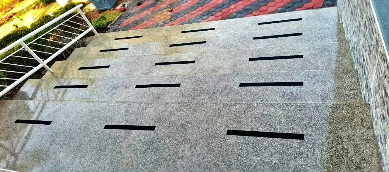 Terrazzo ramp Harare — wide terrazzo access ramp with black anti-slip inlay strips set into the surface, Borrowdale Zimbabwe