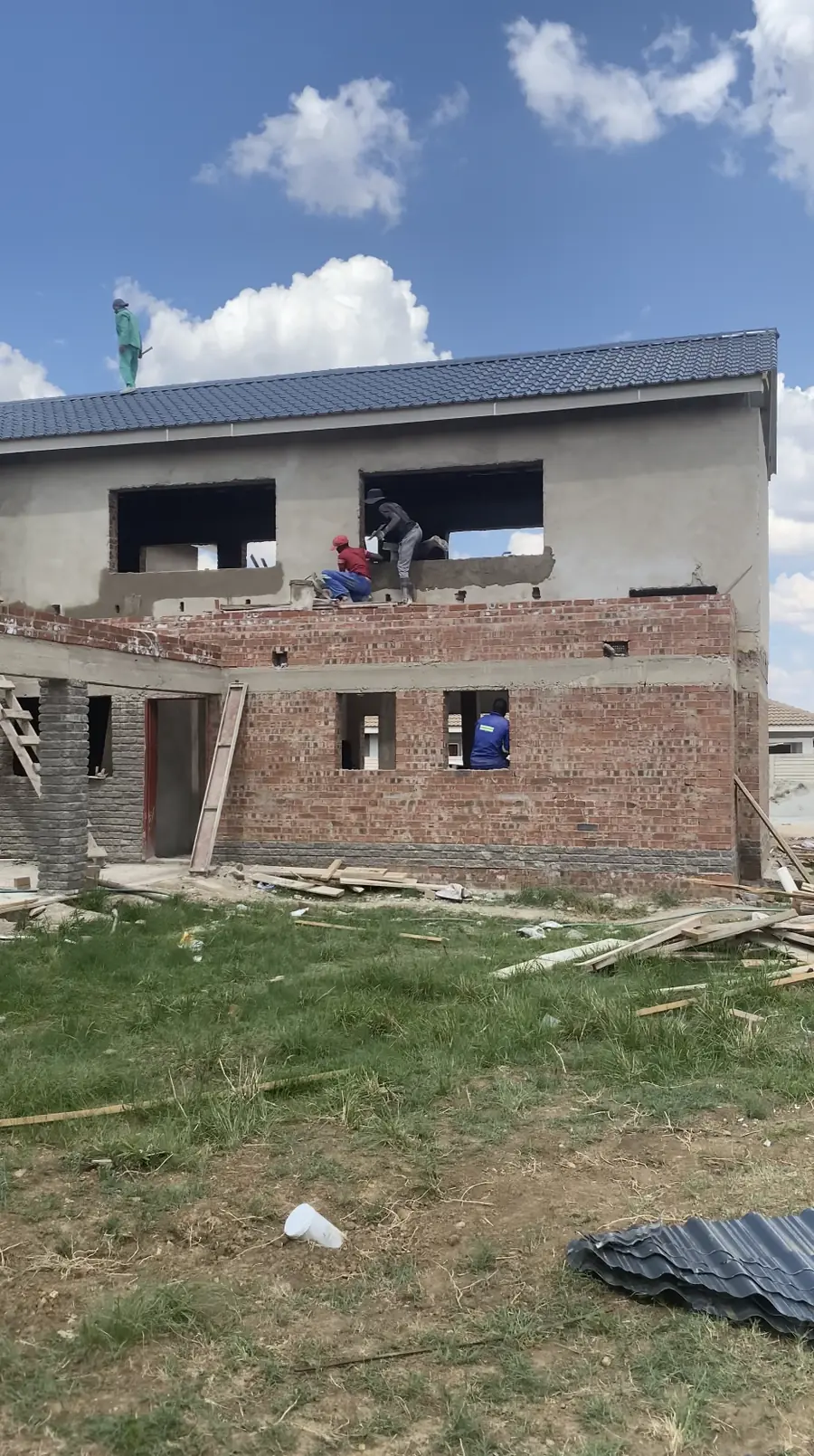 Building contractors Harare — brickwork and roof structure under construction on a double-storey house in Westgate, Zimbabwe